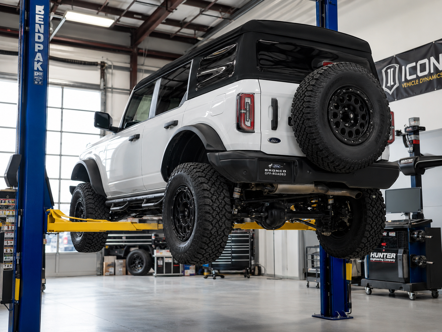 Lifted 4x4 on an alignment rack inside the SunCoast Off-Road shop