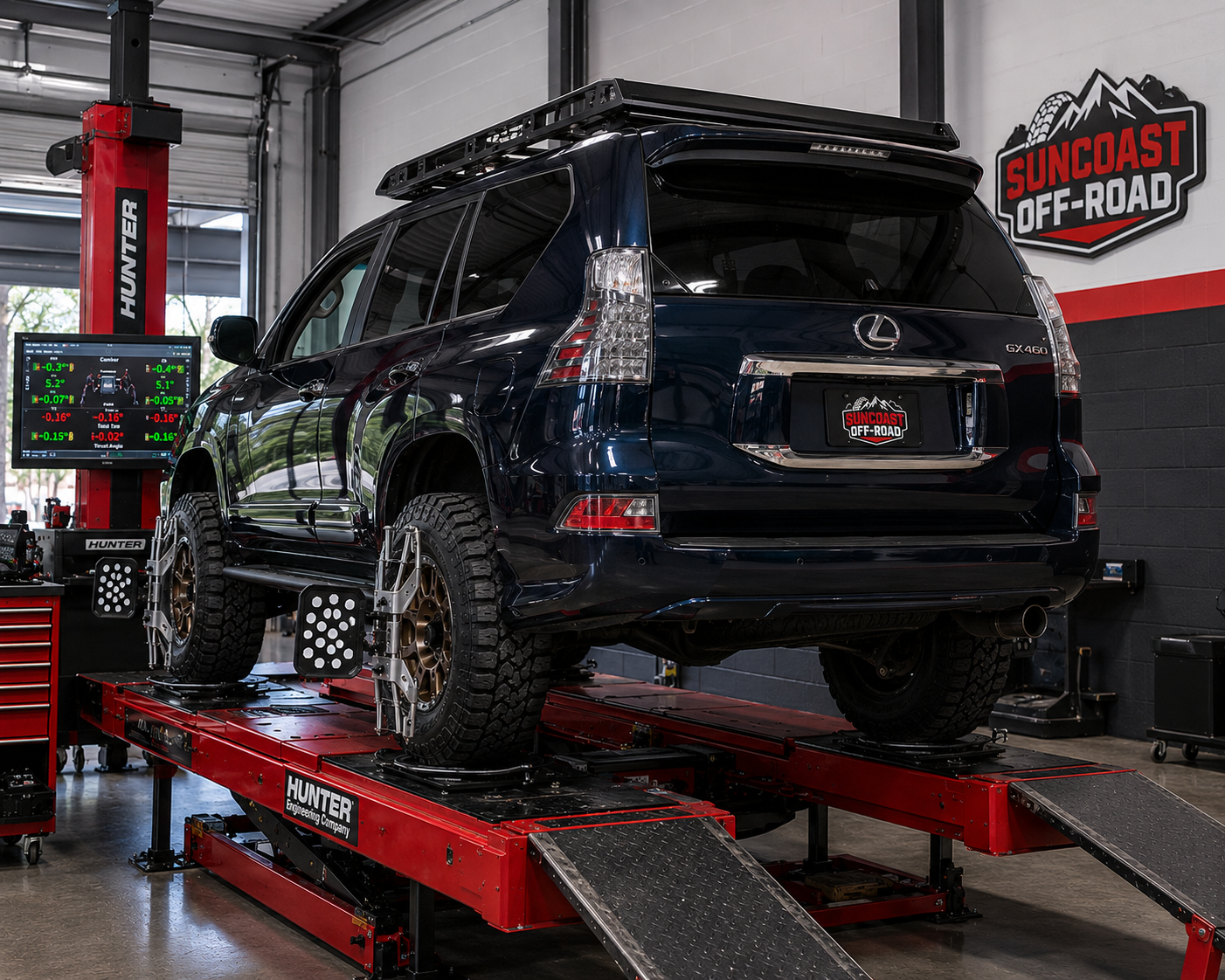 Lifted Lexus GX460 with bronze wheels on a Hunter alignment rack at SunCoast Off-Road